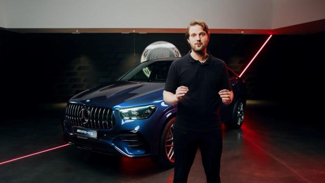 Product manager standing in a show room in front of the new Mercedes-AMG GLE 53 Coupé