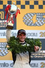 Maro Engel mit Siegerkranz streckt den Pokal in die Luft