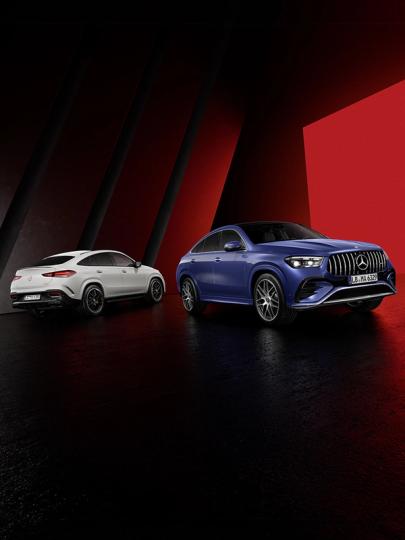Ein Mercedes-AMG GLE 63 S Coupé und ein Mercedes-AMG GLE 53 Coupé stehen im Showroom nebeneinander.