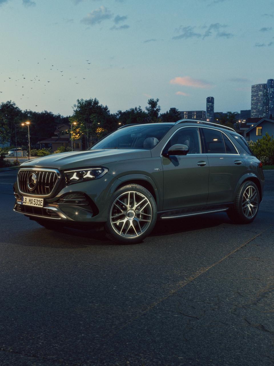 A Mercedes-AMG GLE 53 SUV with a city in the background