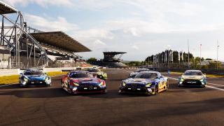Mercedes-AMG GTs parked on a straight section of a racetrack