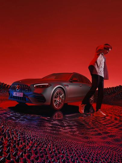 George Rusel next to a Mercedes-AMG C 63 S E PERFORMANCE Estate