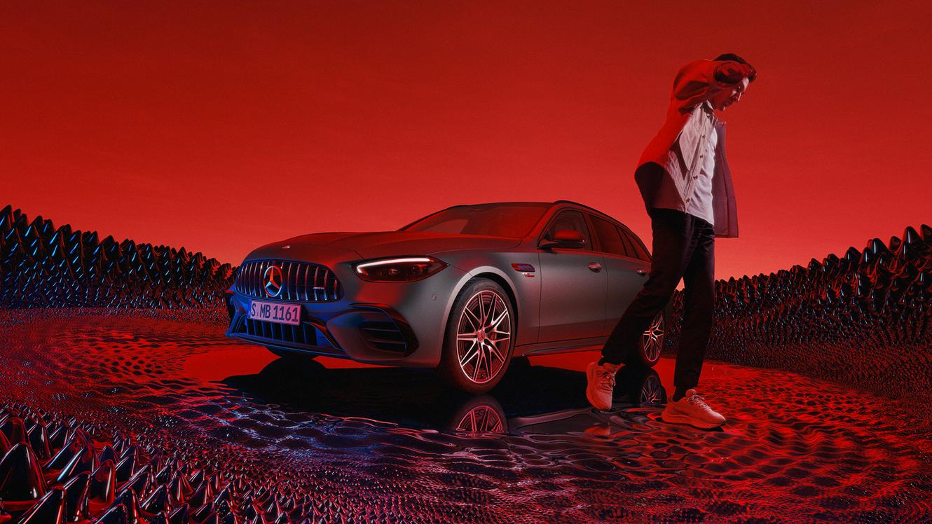 George Rusel next to a Mercedes-AMG C 63 S E PERFORMANCE Estate