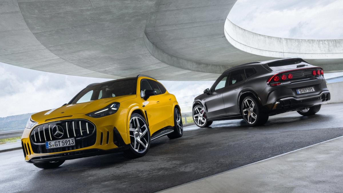 The Mercedes-AMG GT 55 and 63 SUVs are parked beneath a motorway slip road